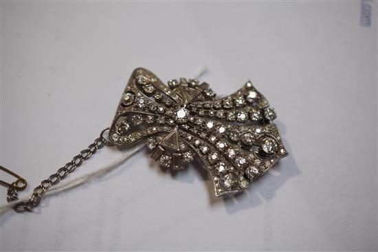 An Art Deco style diamond and platinum openwork claw, collet and pave-set fan shaped brooch, 52mm.
